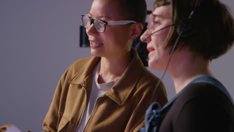 female film director and assistant shooting movie or video discussing scene in studio shot in real time 1