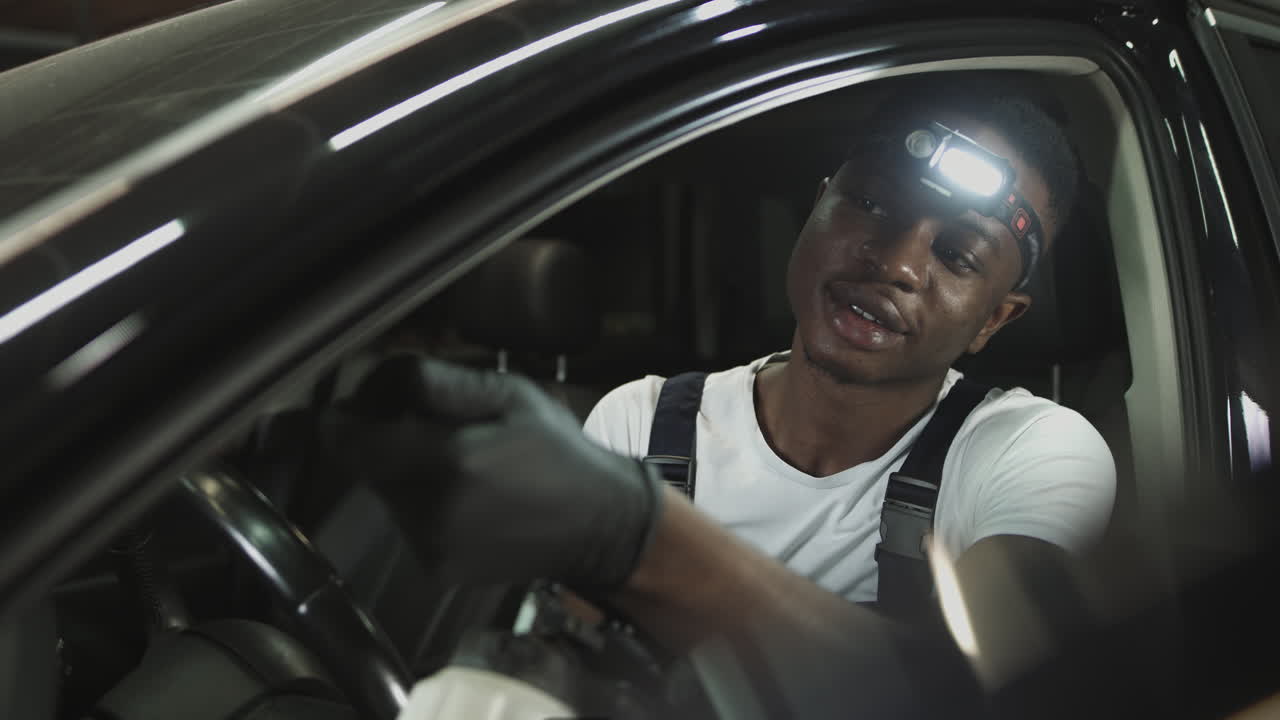 Car Mechanic Inspecting Car Interior