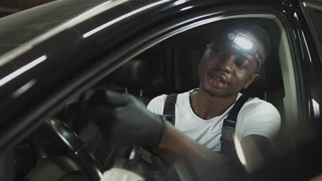 car mechanic inspecting car interior