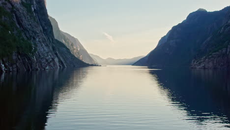 dolly shot, pushing in low and slow over lysefjord in norway