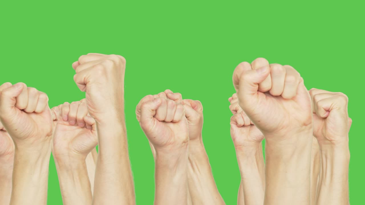 Human moving up clenched fist on meeting isolated on green background. Gestures hand fist up on green chroma key background. Alpha channel, keyed green screen.