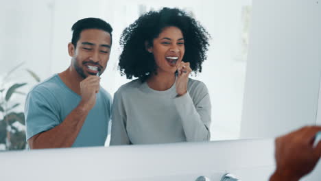 Interracial-couple,-brushing-teeth