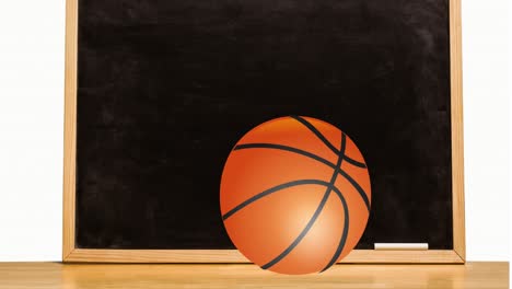 animation of basketball rolling on table over black board and white chalk against white background