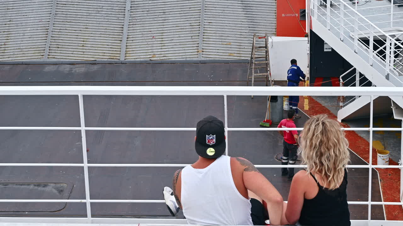 THASOS, GREECE - SEPTEMBER 23, 2020: A couple sitting, talking and eating on a floating ferryboat