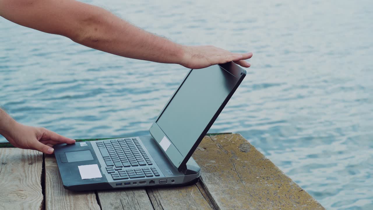 Man's hands using laptop computer.
