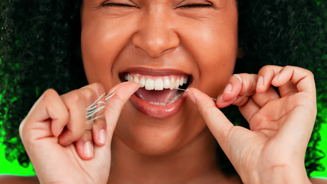 Woman, face and dental flossing on green screen