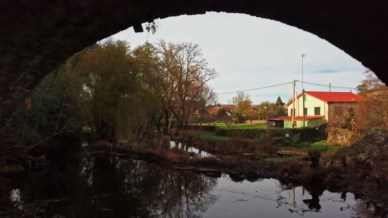Aerial Shot Flying Under Ancient Bridge on the Camino De Santiago Trail in Spain