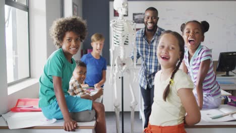 Video-of-happy-african-american-teacher-with-class-of-diverse-pupils-during-anatomy-lesson