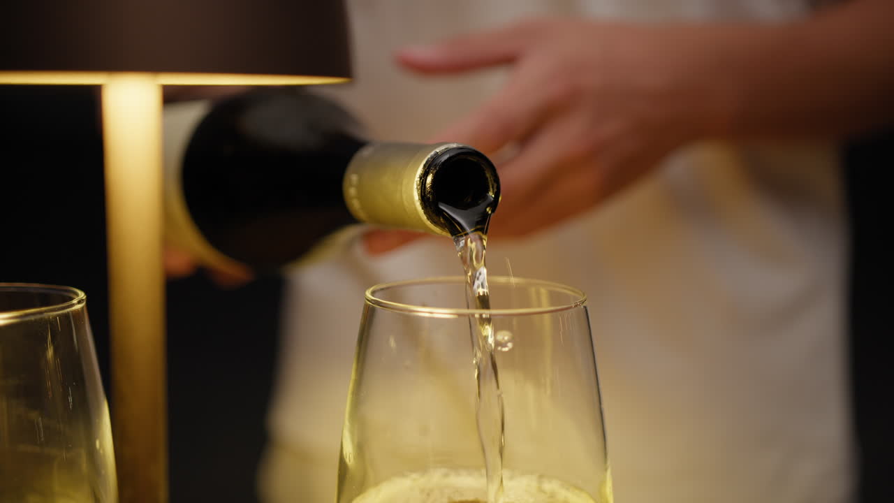 Waiter Pouring Expensive Wine Into The Glasses For The Customers