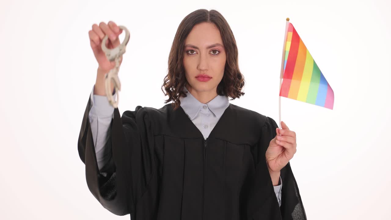 Woman in Judge's Robe with Rainbow Flag and Handcuffs Symbolizing LGBTQ+ Rights and Justice