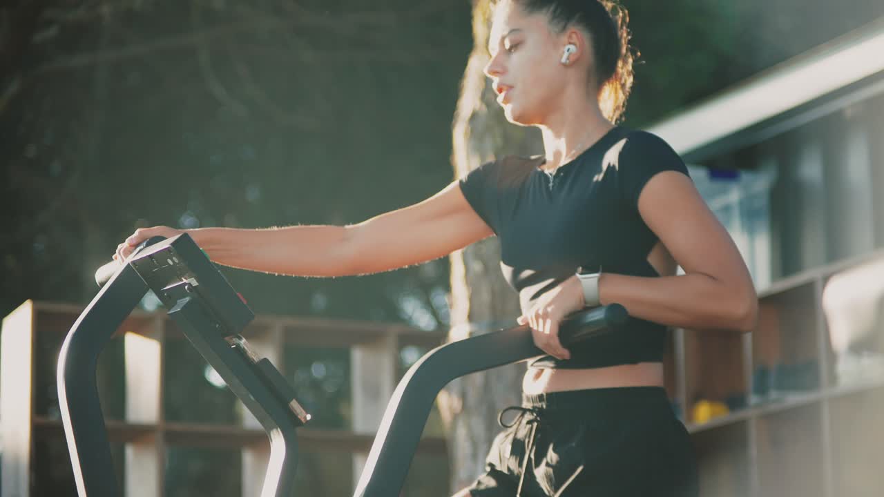 Woman exercising on elliptical machine