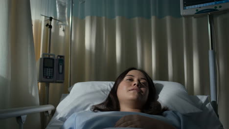 woman resting in hospital bed