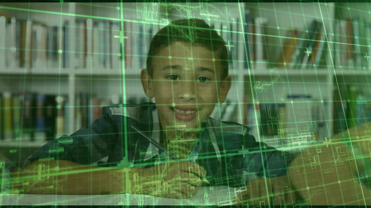 Green technical grid fading in over library table assisting school boy writing notes and smiling