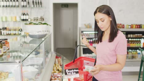 Animation-of-happy-biracial-woman-shopping-for-food