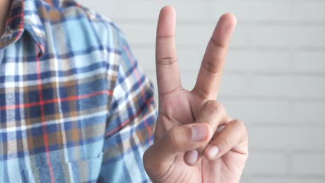 man showing peace sign