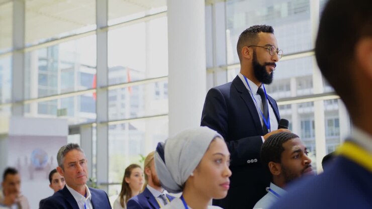 Mixed-race businessman listening to the speaker in the business seminar 4k