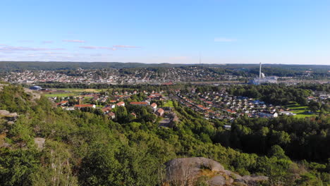 aerial drone flying up above trees in east gotheburg revealing peaceful suburbs area, sweden, day