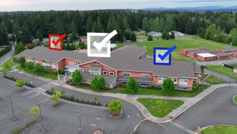 aerial view of a school with voting checkmarks appearing overhead