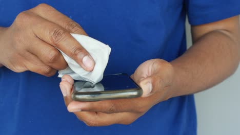 cleaning a smartphone with a microfiber cloth