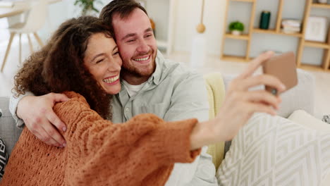 Couple,-phone-selfie-and-home-memories-laughing