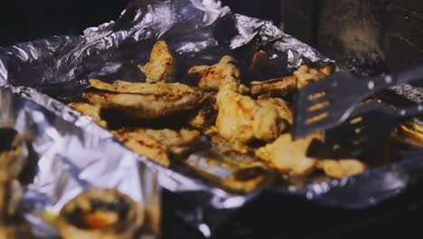 afternoon standing footage from the roasting overheated and sliced chicken meats above the sligtly burned wood pile with rollover