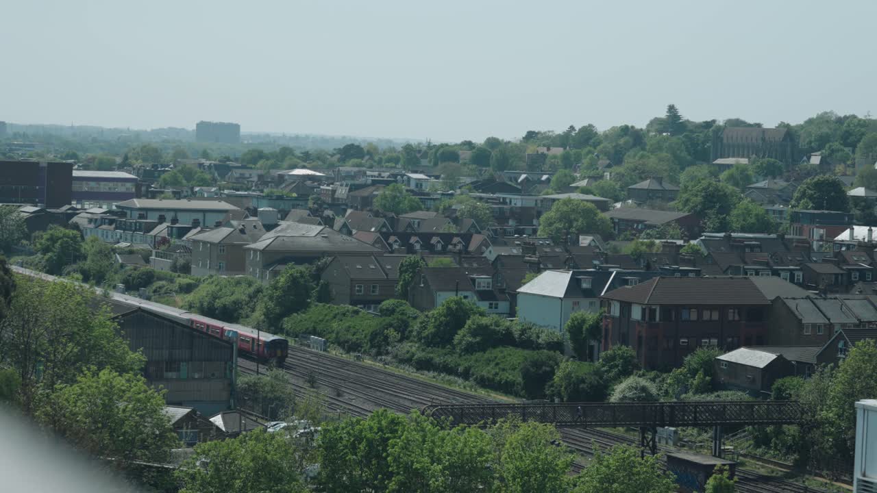 Shot of London cityscape from a viewpoint with metros passing by in UK