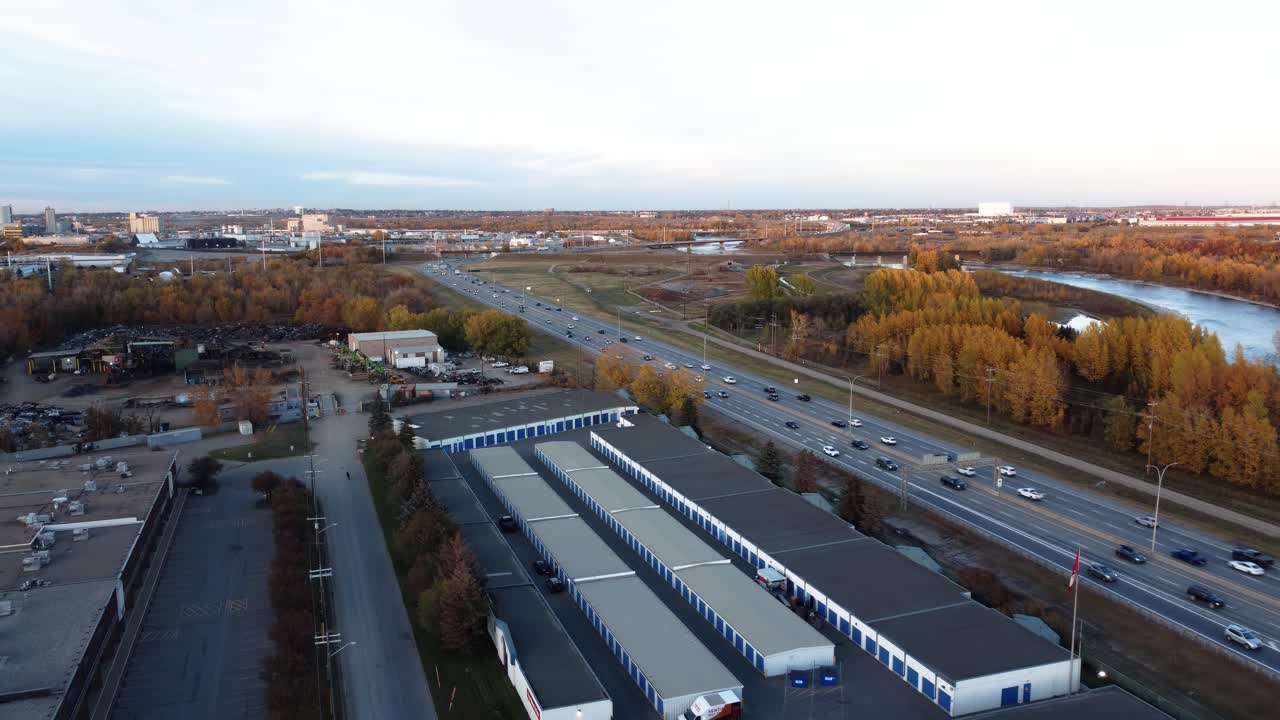 Heavy rush hour traffic on Calgary's Deerfoot Highway, surrounded by beautiful orange fall trees