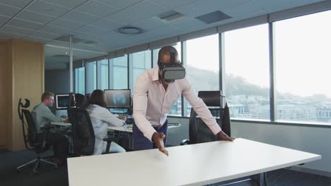 african american businessman wearing vr headset in modern office