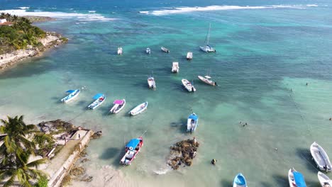 Beautiful-drone-shot-of-Akumal-Bay-with-its-crystal-clear-waters-and-tall-palm-trees