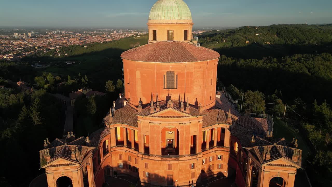 Elevated view of the Sanctuary of Madonna di San Luca amidst lush greenery in Bologna, Italy