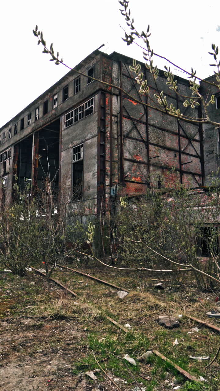 Abandoned factory. Ruins of a very heavily polluted industrial factory Vertical video