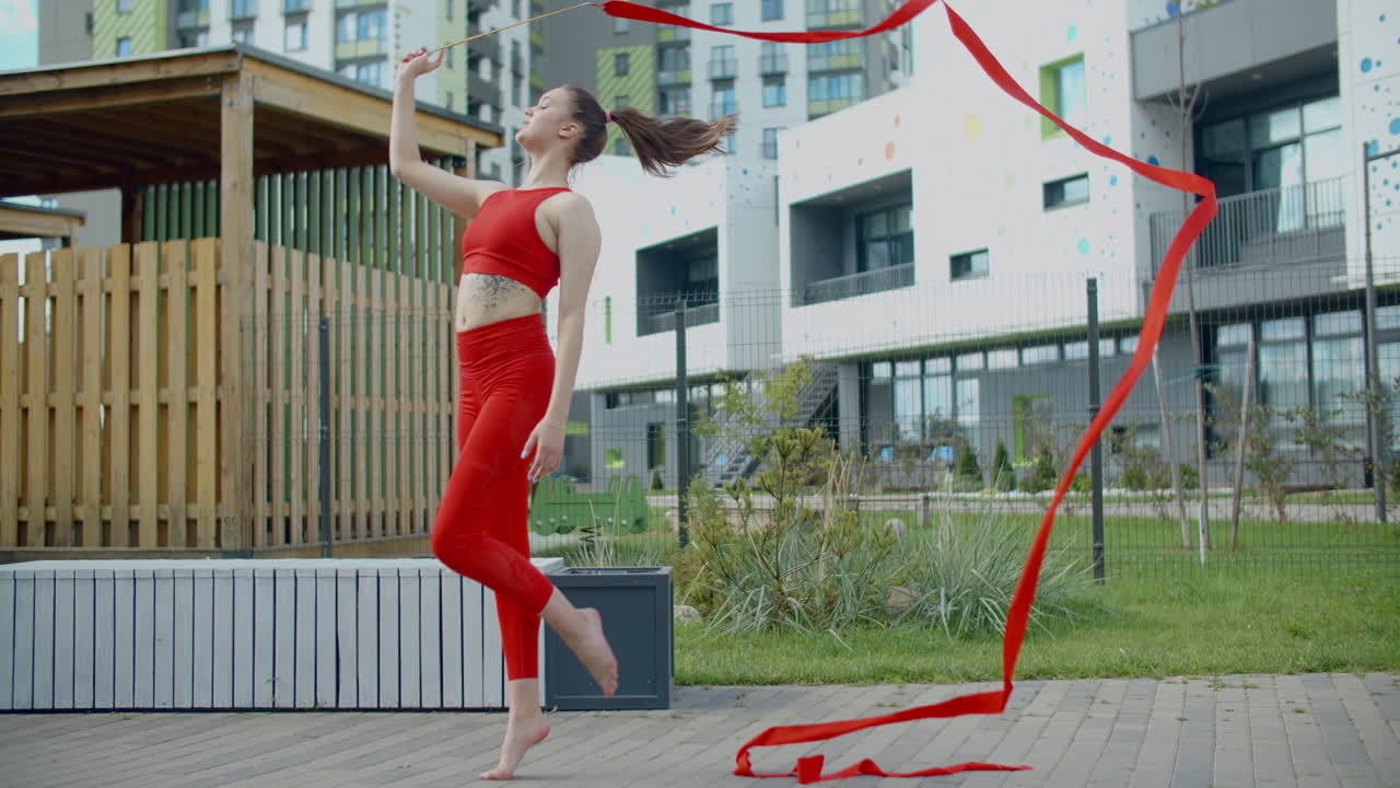 Woman performing ribbon dancing outdoors