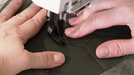 craftsman sews the pocket pouch on sewing machine close up