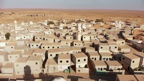 aerial shot of two mosques at palestine near gaza in the desert at an empty city