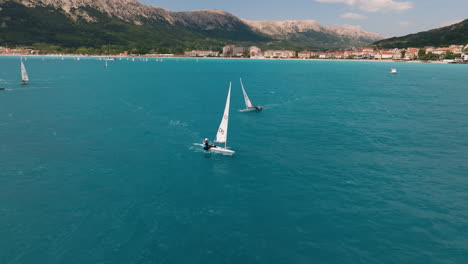 Sail-Boat-Regatta-In-Baska,-Krk,-Croatia---aerial-drone-shot