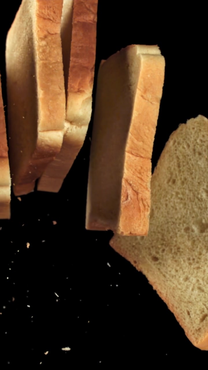 Fresh White Bread Slices Falling Against Black Background
