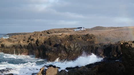 ocean waves crashing on the rocky coastline of lanzarote, canary islands, spain. wide shot