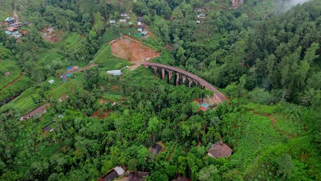 breathtaking aerial drone footage of a train crossing the iconic nine arches bridge in ella, sri lanka.