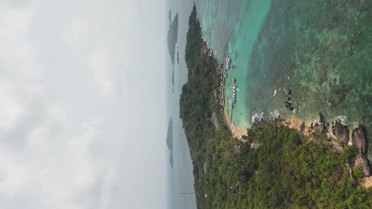 vertical aerial shot of the Phu Quoc rocky coastline with a busy harbour