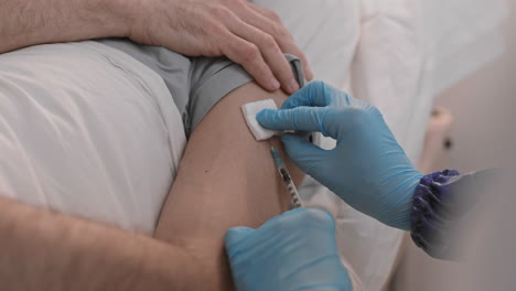 giving vaccine shot to unrecognizable patient