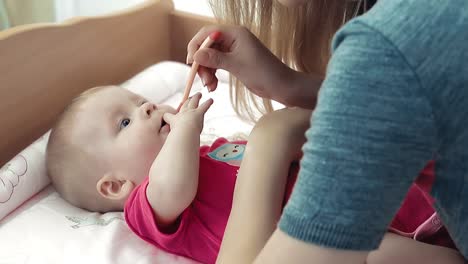 pretty young mother feeding baby