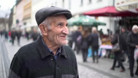 an elderly man walks with a joyful expression through a bustling street market. the scene is filled with people and stalls, capturing the vibrant atmosphere and sense of community.