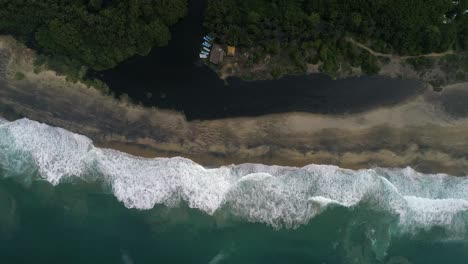 aerial cenital drone shot of the beach and the black lagoon in the mangrove la ventanilla, oaxaca