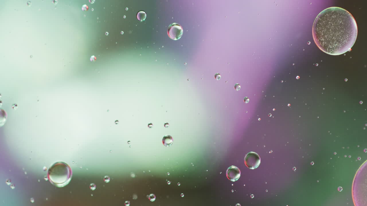 Animation of bubbles moving on green and purple background with copy space