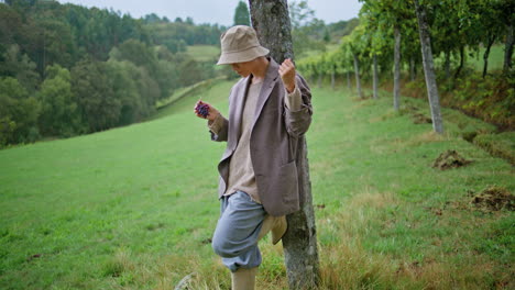 woman eating grapes in a vineyard