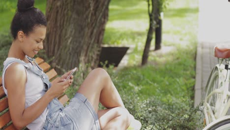 content girl using smartphone in park