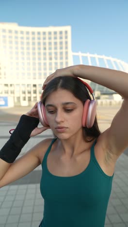 teenage girl listening to music in a city park