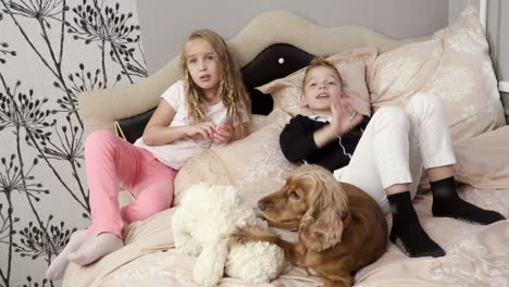 girl, boy and dog lie on the bed