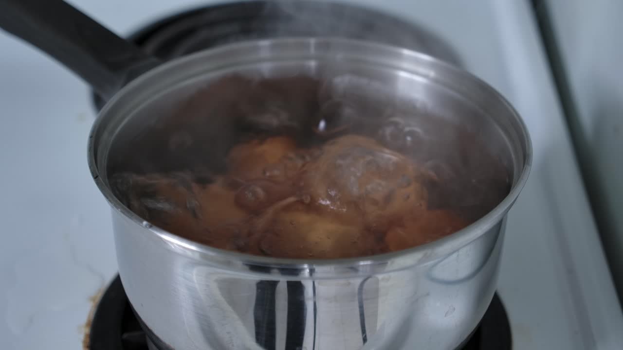 Cooking Hard-Boiled Organic Eggs Over Pot In The Stove