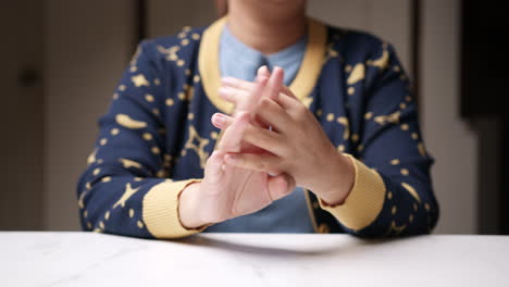 Close-up-of-a-person's-hand-as-she-is-sqeezing-them-alternately-and-stretching-them-at-the-same-time,-to-relieve-herself-of-the-pain-that-she-is-feeling